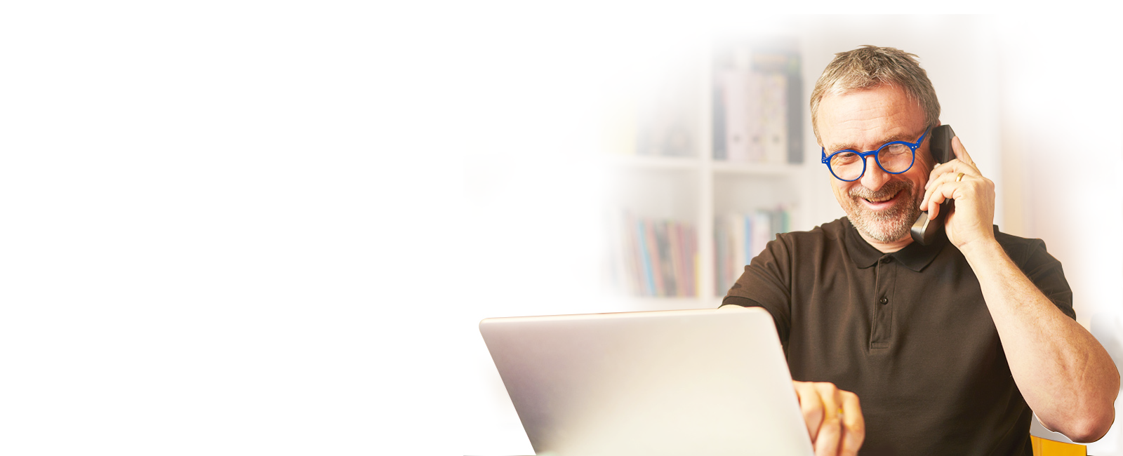 man on the phone in front of computer